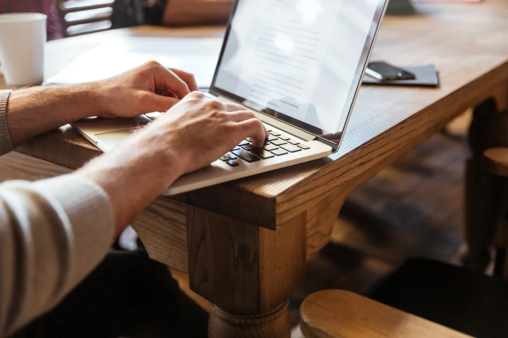Professional content creator typing SEO-optimized article for guest post placement and contractor backlink building